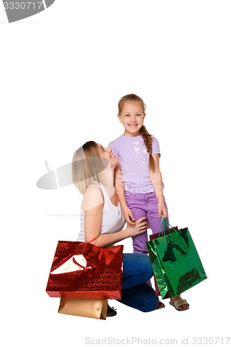 Image of Happy a mother and daughter with shopping bags standing at studio 