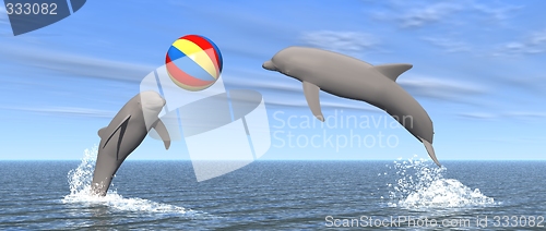Image of dolphins palying with ball