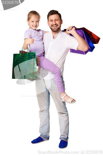 Image of Happy father and daughter with shopping bags standing at studio 