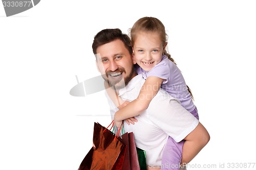 Image of Happy father and daughter with shopping bags standing at studio 