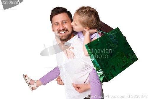 Image of Happy father and daughter with shopping bags standing at studio 