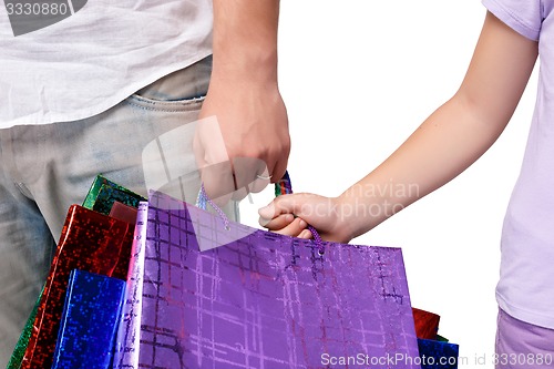 Image of Happy father and daughter with shopping bags standing at studio 