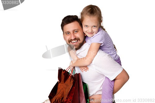Image of Happy father and daughter with shopping bags standing at studio 