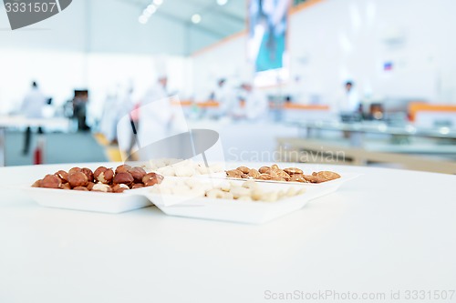 Image of nuts mix in square paper plates