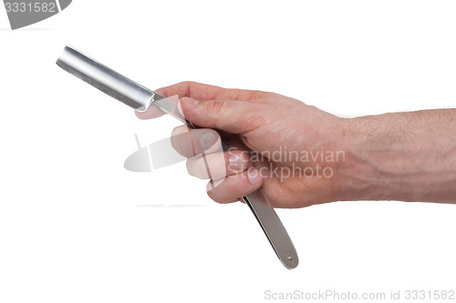 Image of Old straight razor held by one hand