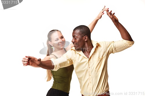 Image of Young couple dances Caribbean Salsa, studio shot