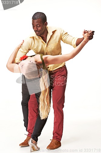 Image of Young couple dances Caribbean Salsa, studio shot
