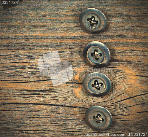 Image of four metal buttons