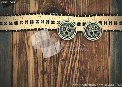 Image of Vintage ribbon with embroidered pattern and ancient classical bu