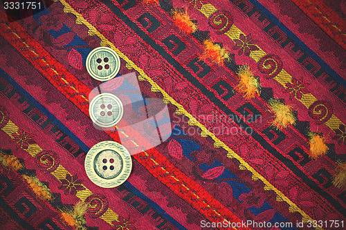 Image of vintage tape with embroidered ornaments and old buttons