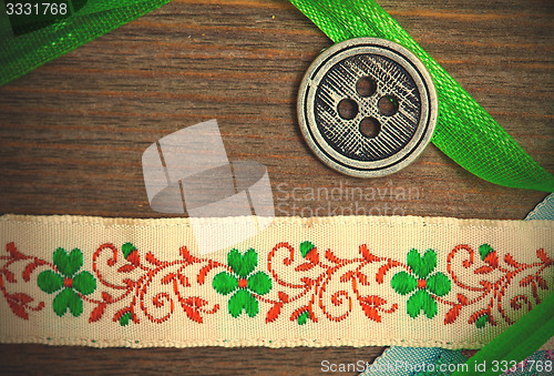 Image of vintage ribbons, tape and one classic button 