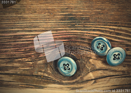 Image of vintage buttons on the aged textured boards