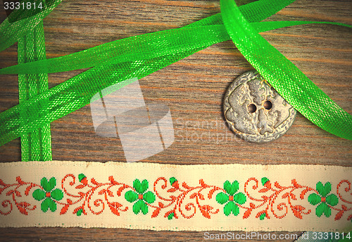 Image of vintage embroidered band and tape with old classic button