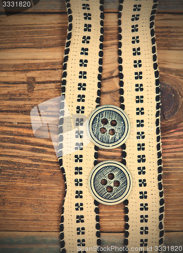 Image of Vintage tape with embroidered pattern and ancient classical butt