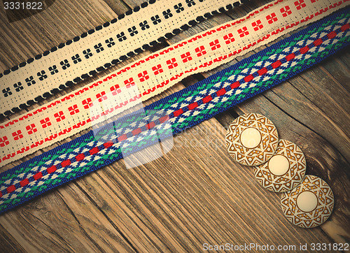 Image of three vintage colored ribbons and buttons