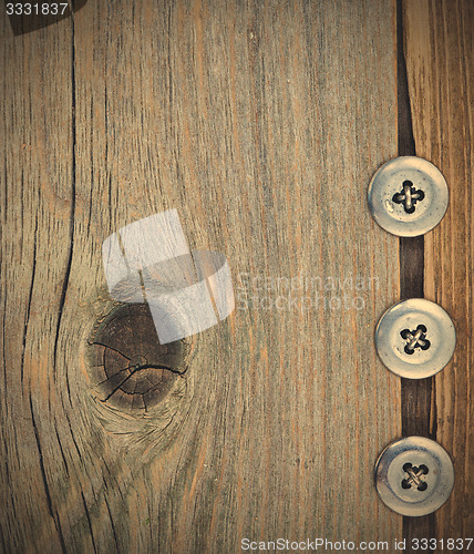 Image of three metal vintage buttons