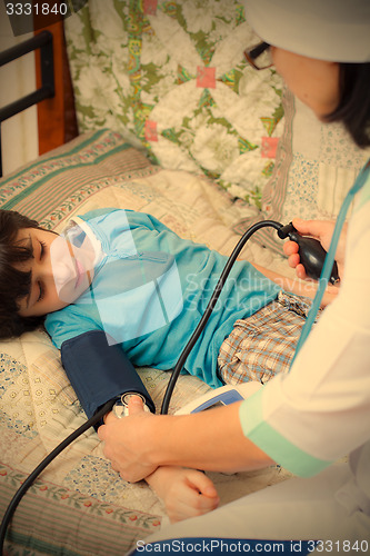 Image of Doctor pediatrician measure blood pressure