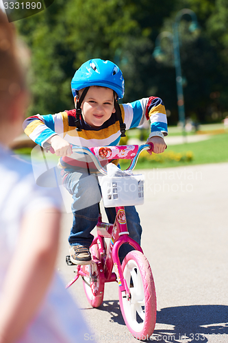 Image of happy boy learning to ride his first bike