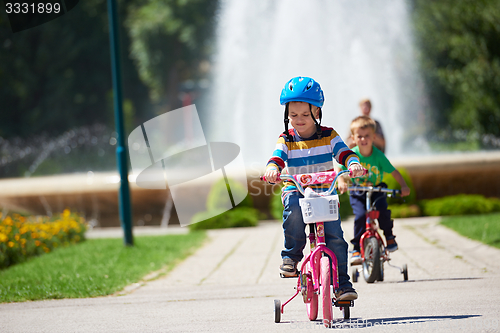 Image of happy boy learning to ride his first bike