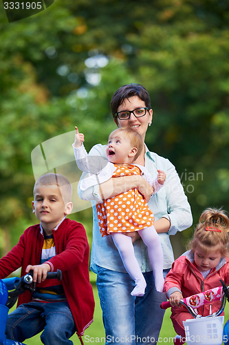 Image of modern mother portrait  with kids in park