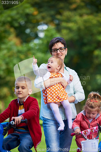 Image of modern mother portrait  with kids in park