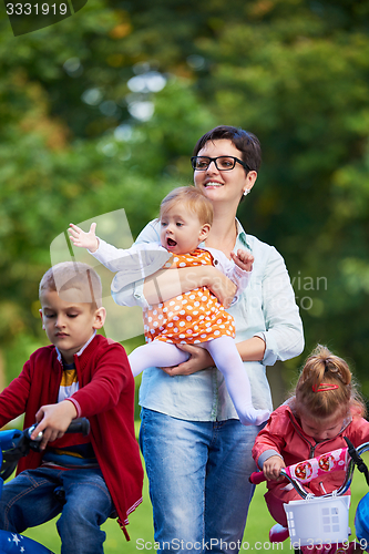 Image of modern mother portrait  with kids in park