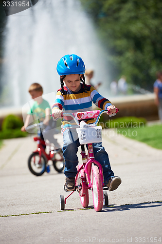 Image of happy boy learning to ride his first bike