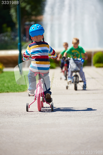 Image of happy boy learning to ride his first bike
