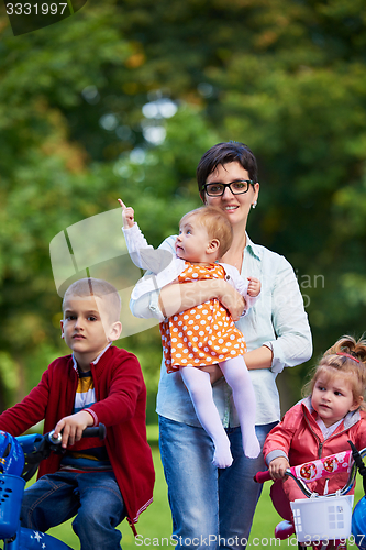 Image of modern mother portrait  with kids in park