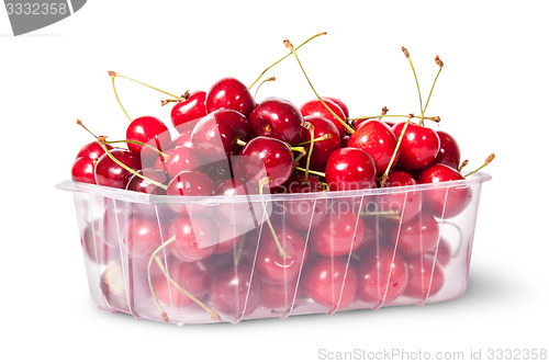 Image of Red juicy sweet cherries in a plastic tray rotated