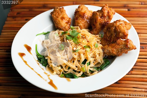 Image of Chicken Wings with Noodles and Spinach