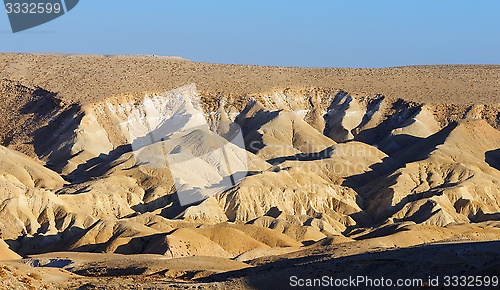 Image of Textured yellow dunes in the desert at sunset 