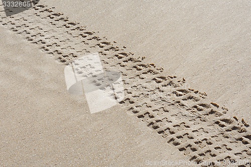 Image of Diagonal track of quad bike on sand