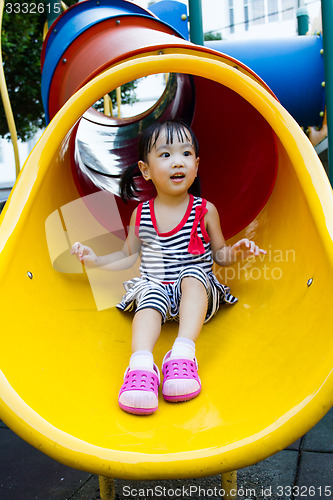 Image of Asian kid sliding on Playground