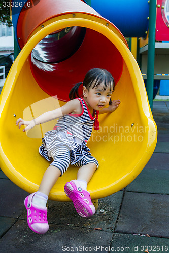 Image of Asian kid sliding on Playground