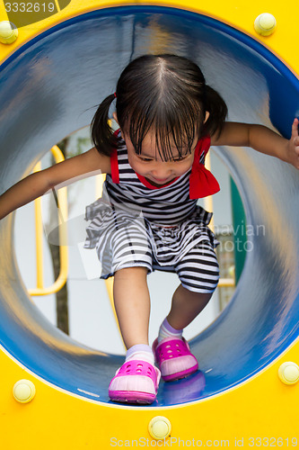 Image of Asian Kid Crawling on Playground Tube
