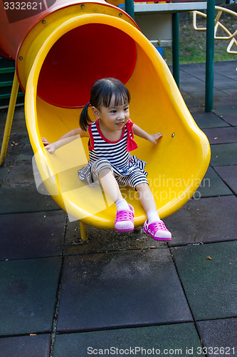 Image of Asian kid sliding on Playground