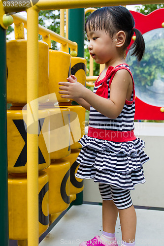 Image of Asian Kid playing on Playground