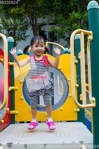 Image of Asian Kid playing on Playground