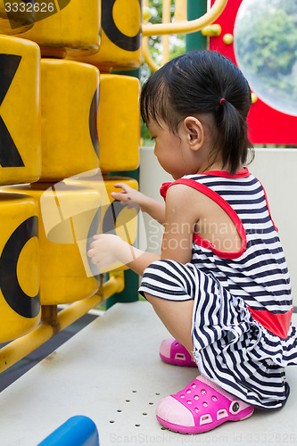 Image of Asian Kid playing on Playground