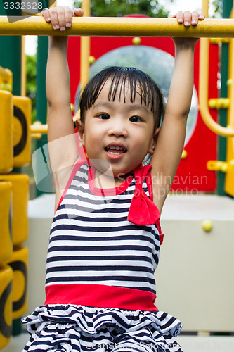 Image of Asian Kid Hanging on bar 