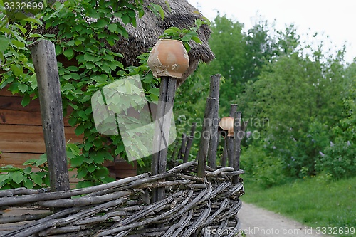 Image of Lath fence with clay pots on top of stakes in open air museum, Kiev, Ukraine