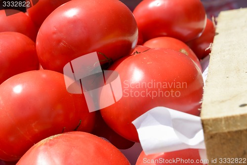 Image of red tomatoes in wooden crates