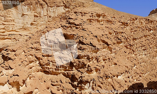 Image of Texture of a brown weathered rock in the desert