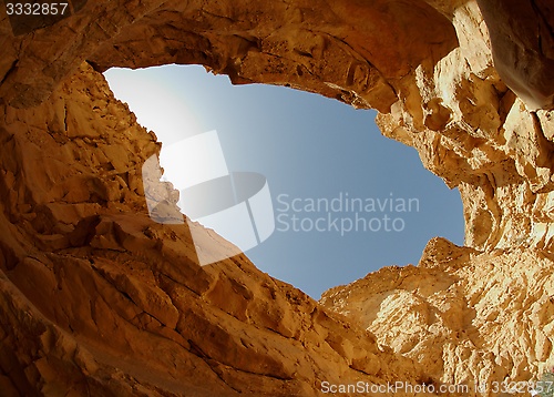 Image of Blue sky seen from the bottom of a desert canyon