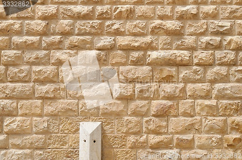 Image of Texture of the wall built of rough yellow stone blocks 