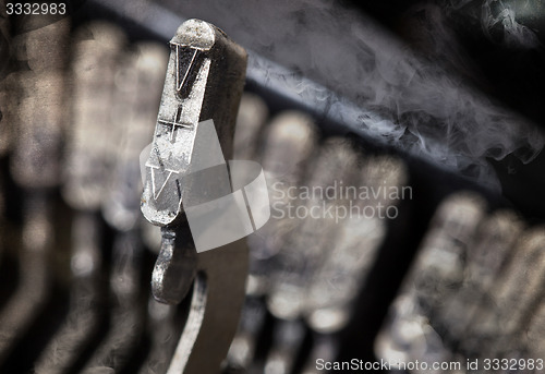 Image of V hammer - old manual typewriter - mystery smoke