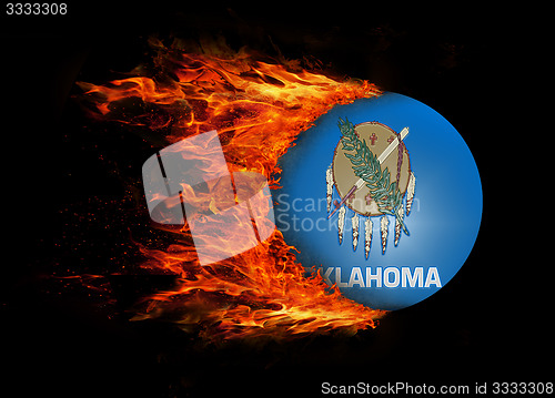 Image of US state flag with a trail of fire - Oklahoma