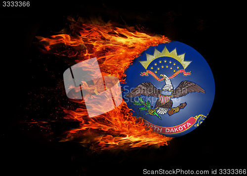 Image of US state flag with a trail of fire - North Dakota