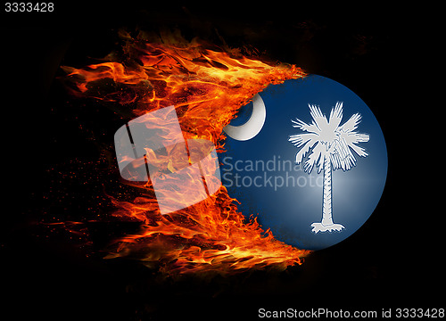 Image of US state flag with a trail of fire - South Carolina